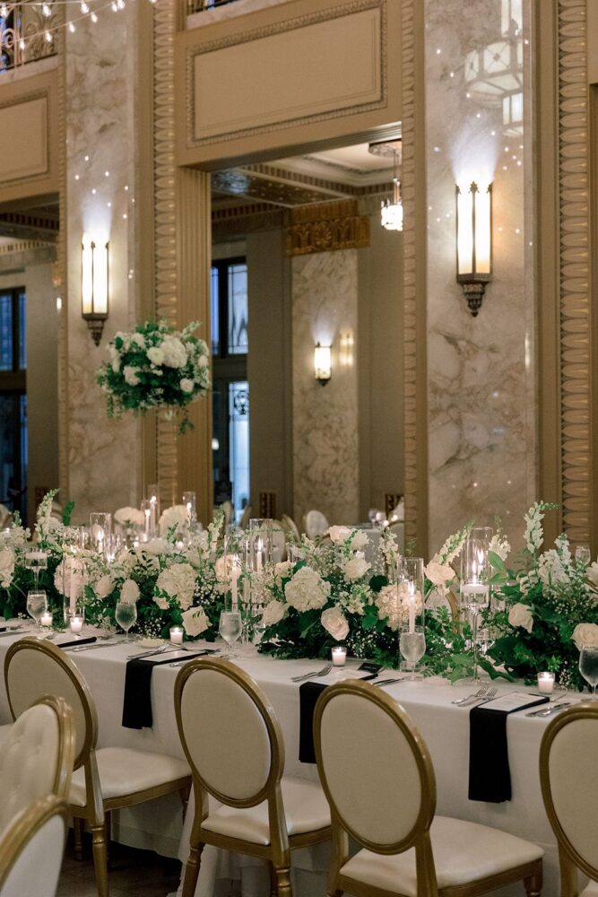 Wedding reception in the Stifel Theatre Grand Lobby with white flowers, candlelight, and string lights