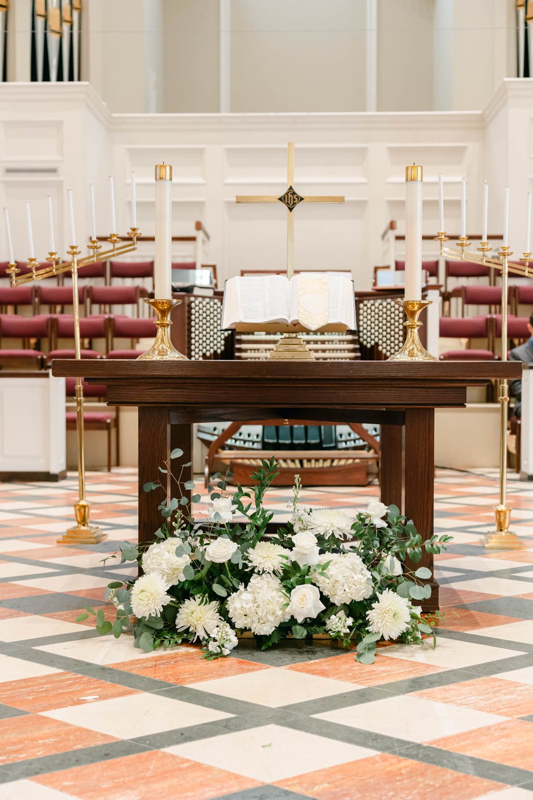 White ground flower arrangement at the church altar