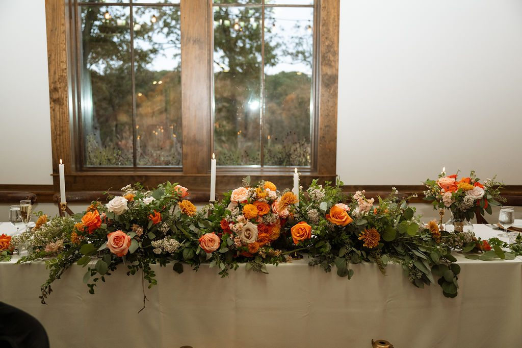 Autumn floral arrangement across the wedding head table at Silver Oaks Chateau